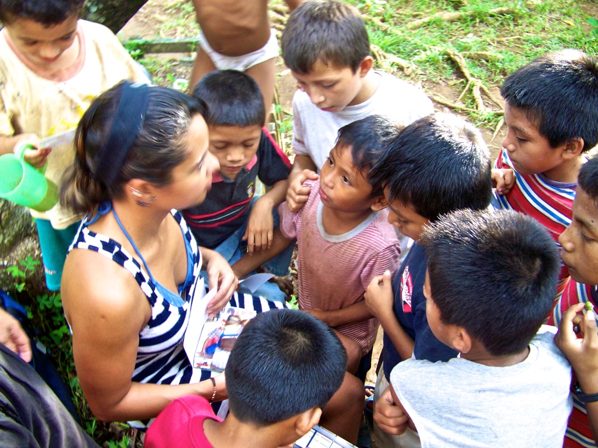 Children at Casa Guatemala gather around Karina, Rio Dulce, Guatemala -- April Beresford